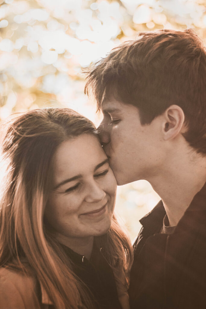 a man kissing a woman's cheek